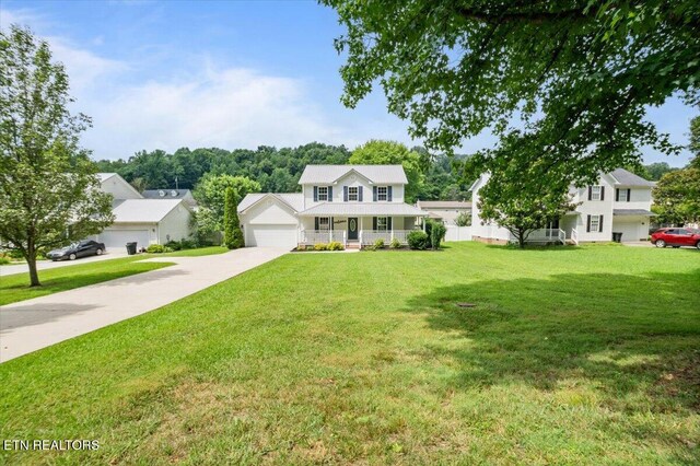 348 Ridge Rd, Caryville, TN 37714 - view of front of property featuring a garage, a front yard, a porch, and driveway