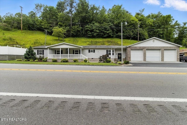 2953 US Highway 119, Pineville, KY 40977 - view of front of house featuring a porch, an attached garage, and crawl space