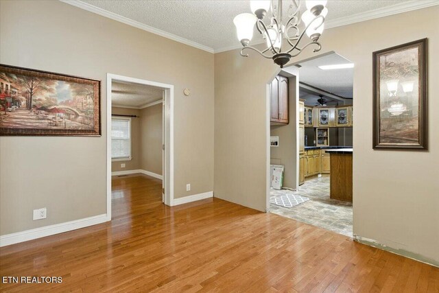 2953 US Highway 119, Pineville, KY 40977 - unfurnished dining area with light wood-type flooring, a chandelier, crown molding, a textured ceiling, and ceiling fan