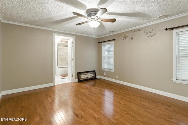 2953 US Highway 119, Pineville, KY 40977 - spare room featuring a textured ceiling, hardwood / wood-style flooring, a ceiling fan, and ornamental molding