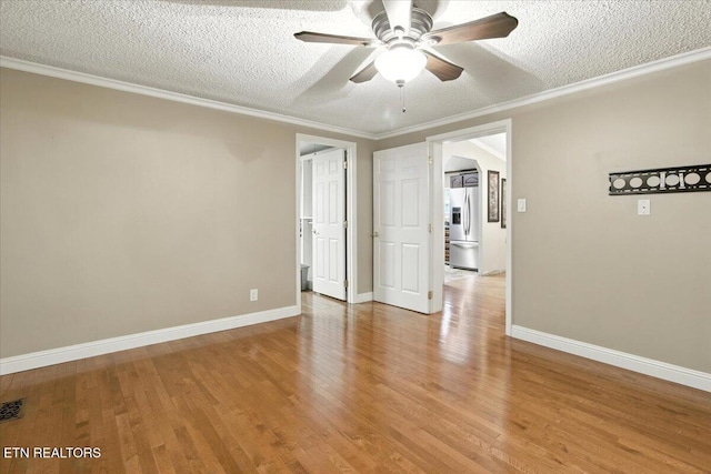 2953 US Highway 119, Pineville, KY 40977 - unfurnished room featuring ceiling fan, a textured ceiling, light wood finished floors, and crown molding