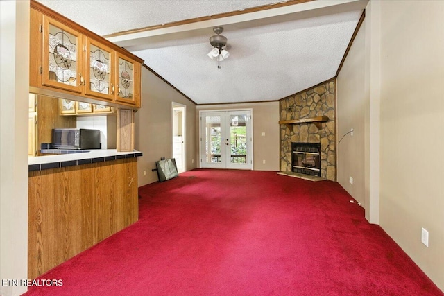 2953 US Highway 119, Pineville, KY 40977 - unfurnished living room featuring carpet, french doors, a fireplace, ornamental molding, and a textured ceiling