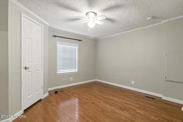 2953 US Highway 119, Pineville, KY 40977 - unfurnished room featuring ornamental molding, hardwood / wood-style floors, ceiling fan, a textured ceiling, and a smoke detector
