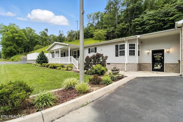 2953 US Highway 119, Pineville, KY 40977 - manufactured / mobile home with covered porch, a front lawn, and asphalt driveway