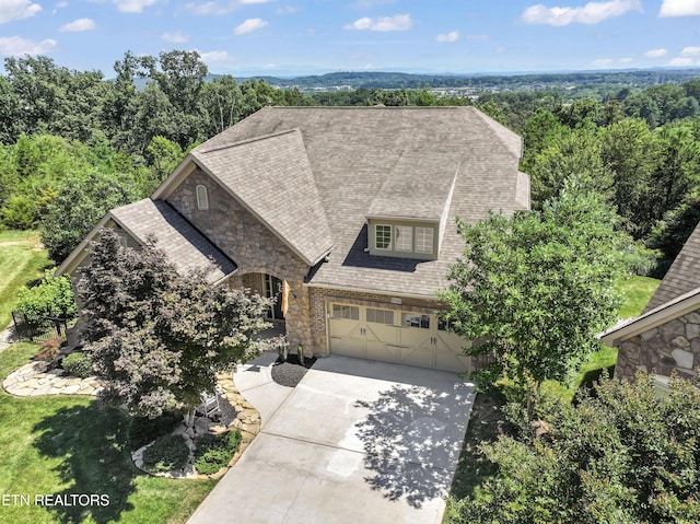 1273 Bishops View Ln, Knoxville, TN 37932 - view of front of house with stone siding, concrete driveway, a garage, and a shingled roof