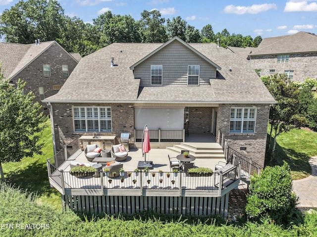 1273 Bishops View Ln, Knoxville, TN 37932 - back of property featuring brick siding, a deck, outdoor dining space, and roof with shingles