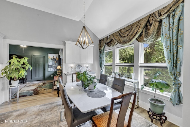 2570 NE Spring Creek Dr, Cleveland, TN 37311 - dining area featuring light wood-style flooring, a chandelier, and high vaulted ceiling