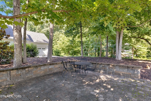 2570 NE Spring Creek Dr, Cleveland, TN 37311 - view of patio with an attached garage and outdoor dining space