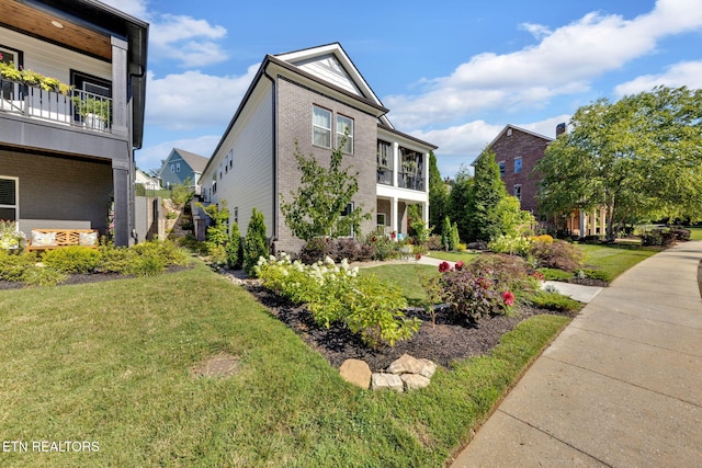 2570 NE Spring Creek Dr, Cleveland, TN 37311 - view of front of property featuring a front yard, brick siding, a balcony, and a residential view