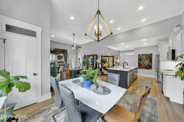 2570 NE Spring Creek Dr, Cleveland, TN 37311 - dining space with a chandelier, light wood-style floors, a ceiling fan, crown molding, and recessed lighting