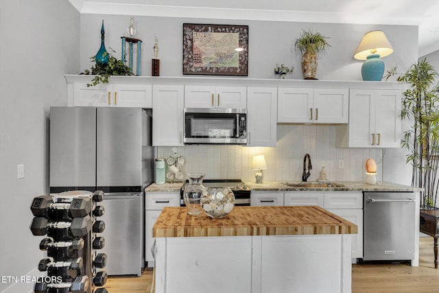 2570 NE Spring Creek Dr, Cleveland, TN 37311 - kitchen with stainless steel appliances, wooden counters, and white cabinets