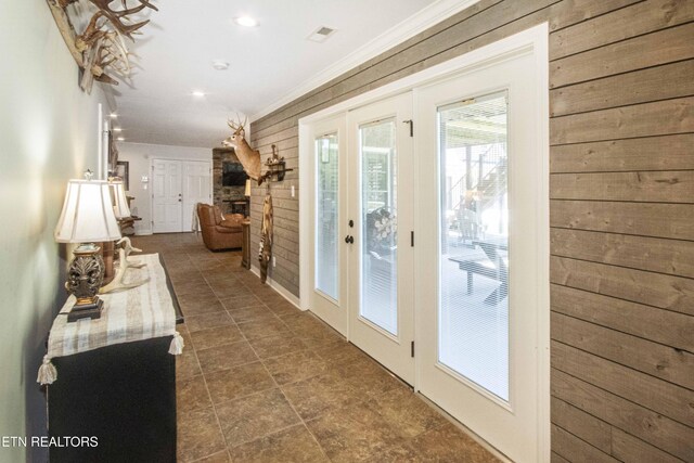 9436 Naff Rd, Heiskell, TN 37754 - entryway featuring wooden walls, crown molding, french doors, recessed lighting, and a stone fireplace