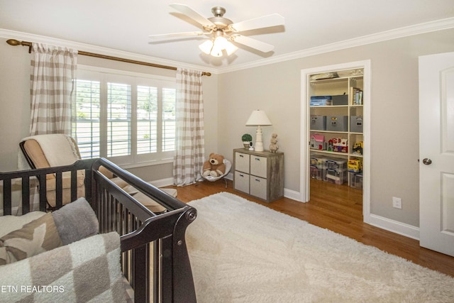 9436 Naff Rd, Heiskell, TN 37754 - bedroom featuring ornamental molding, wood finished floors, a spacious closet, and ceiling fan