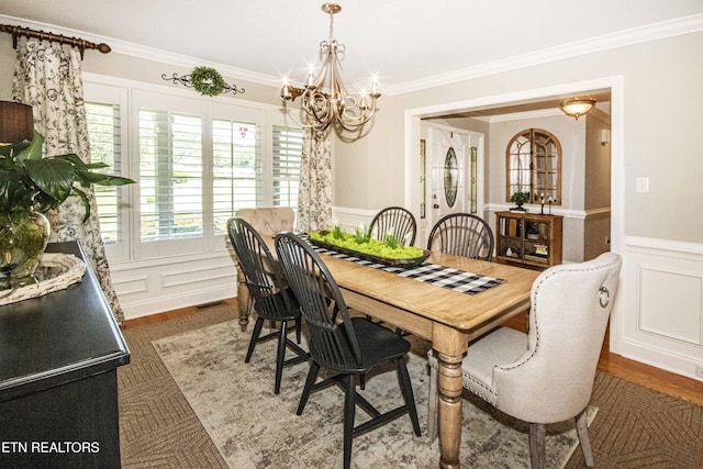 9436 Naff Rd, Heiskell, TN 37754 - dining space featuring a decorative wall, a chandelier, ornamental molding, a wainscoted wall, and wood finished floors