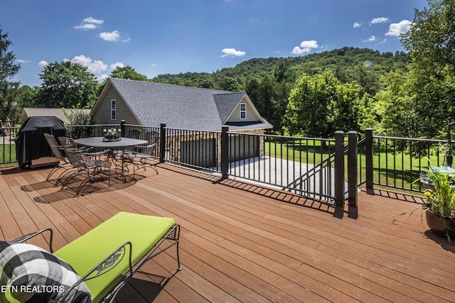 9436 Naff Rd, Heiskell, TN 37754 - deck featuring outdoor dining area, area for grilling, and a forest view