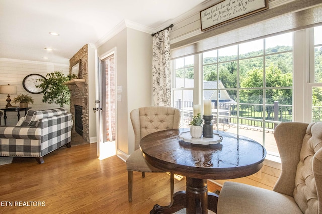 9436 Naff Rd, Heiskell, TN 37754 - dining space with ornamental molding, wood finished floors, a large fireplace, and plenty of natural light