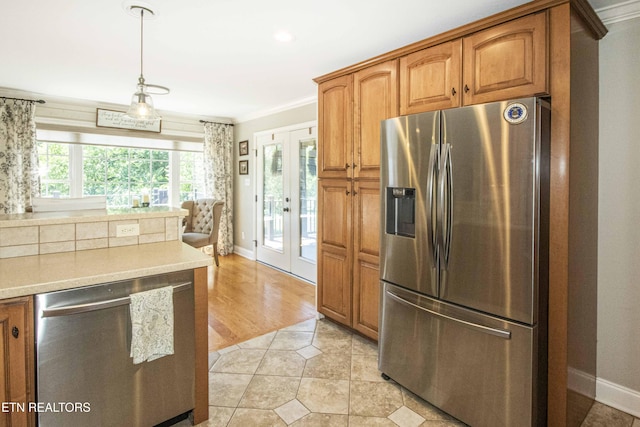 9436 Naff Rd, Heiskell, TN 37754 - kitchen featuring stainless steel appliances, french doors, light countertops, brown cabinetry, and crown molding