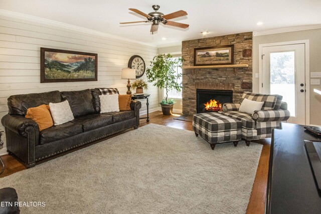 9436 Naff Rd, Heiskell, TN 37754 - living area with ornamental molding, plenty of natural light, a fireplace, ceiling fan, and wood finished floors