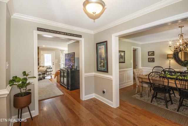 9436 Naff Rd, Heiskell, TN 37754 - hall featuring crown molding, wood finished floors, a chandelier, and a wainscoted wall