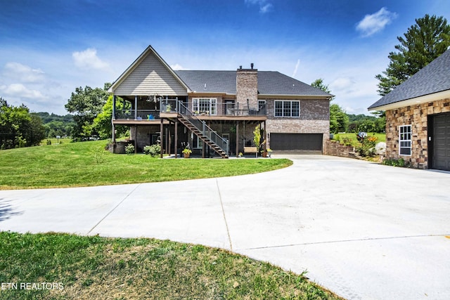 9436 Naff Rd, Heiskell, TN 37754 - view of front of house with stairway, an attached garage, driveway, a deck, and a front lawn