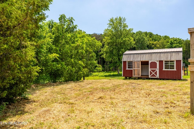 1768 Fain Cemetery Rd, Dandridge, TN 37725 - view of green lawn featuring a storage shed and a wooded view