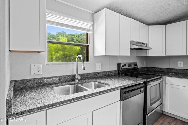1768 Fain Cemetery Rd, Dandridge, TN 37725 - kitchen featuring under cabinet range hood, stainless steel appliances, white cabinets, and a textured ceiling