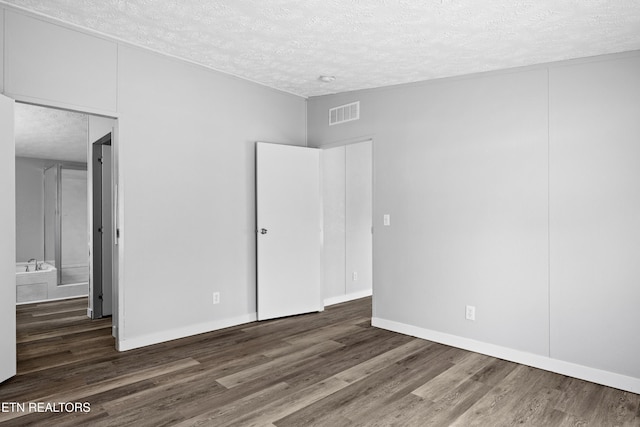 1768 Fain Cemetery Rd, Dandridge, TN 37725 - unfurnished bedroom featuring a textured ceiling and wood finished floors
