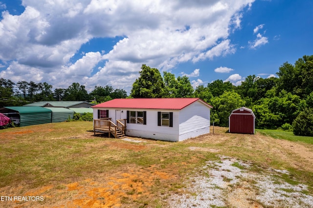 1768 Fain Cemetery Rd, Dandridge, TN 37725 - view of front of house featuring driveway, a shed, a front yard, crawl space, and a metal roof