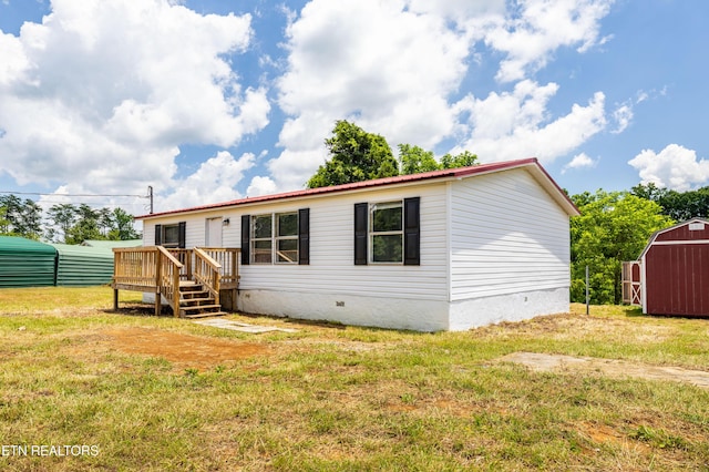 1768 Fain Cemetery Rd, Dandridge, TN 37725 - view of front of house featuring crawl space, a shed, a front yard, a wooden deck, and a metal roof