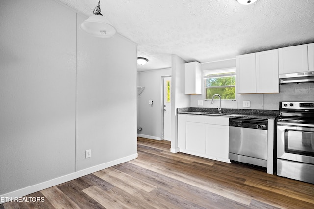 1768 Fain Cemetery Rd, Dandridge, TN 37725 - kitchen with appliances with stainless steel finishes, under cabinet range hood, dark countertops, a textured ceiling, and white cabinetry