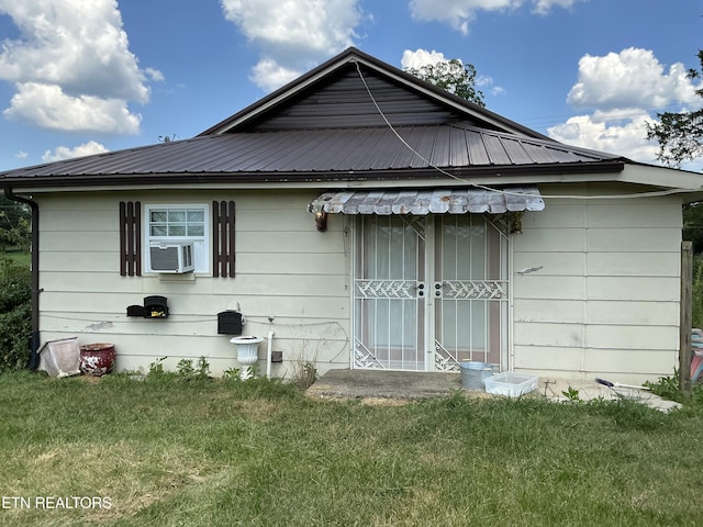 1890 Doaks Creek Rd, Speedwell, TN 37870 - rear view of house featuring a metal roof, a lawn, and cooling unit