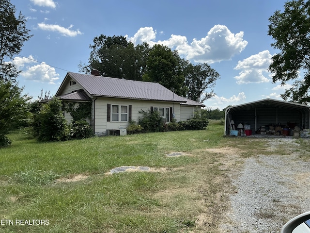 1890 Doaks Creek Rd, Speedwell, TN 37870 - view of front of home featuring a carport, driveway, a front lawn, and a metal roof