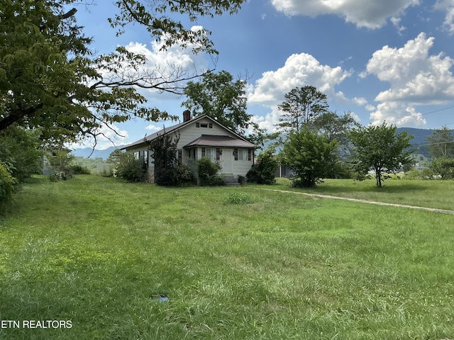 1890 Doaks Creek Rd, Speedwell, TN 37870 - view of property exterior with a chimney and a lawn