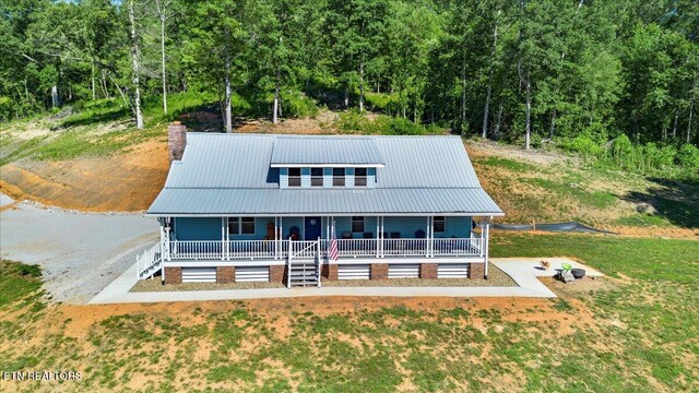 2270 Cove Pointe Rd, Lafollette, TN 37766 - view of front of house with covered porch, a chimney, a view of trees, and a metal roof
