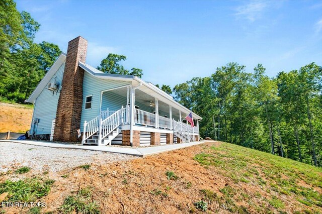 2270 Cove Pointe Rd, Lafollette, TN 37766 - view of property exterior with stairway, a chimney, and a porch