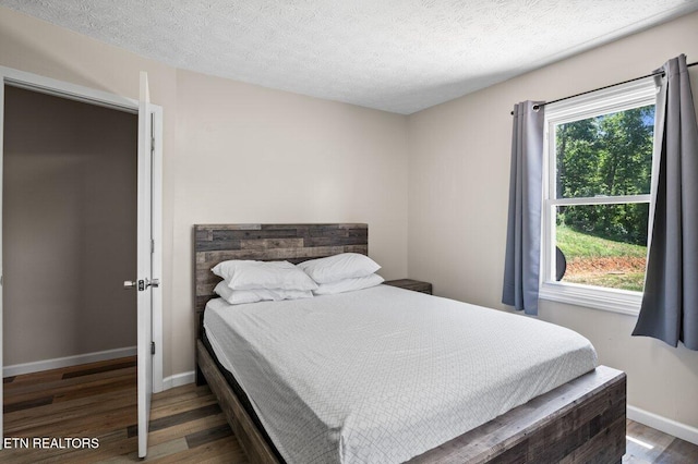 2270 Cove Pointe Rd, Lafollette, TN 37766 - bedroom with wood finished floors and a textured ceiling