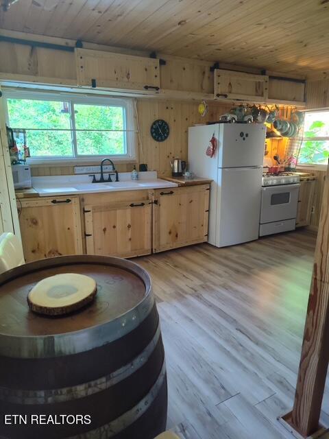 419 River Rd, Huntsville, TN 37756 - kitchen featuring white appliances, wood ceiling, light brown cabinets, plenty of natural light, and light wood-style flooring