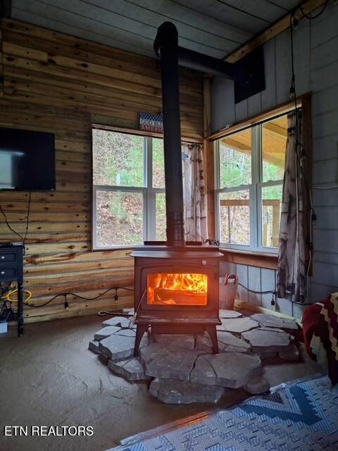 419 River Rd, Huntsville, TN 37756 - interior space with a wood stove and wood walls