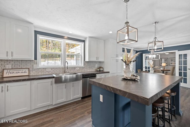 750 Everett Rd, Farragut, TN 37934 - kitchen with stainless steel dishwasher, dark wood-style flooring, a kitchen island, white cabinets, and crown molding