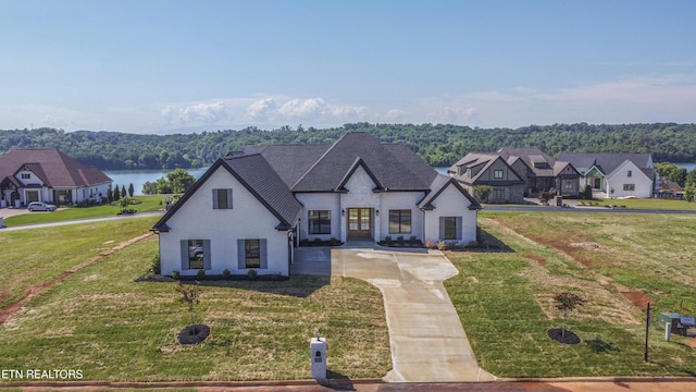 256 Watercrest Dr, Vonore, TN 37885 - french country inspired facade with driveway, a front lawn, french doors, and a water view