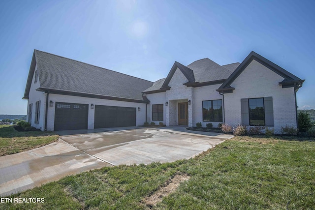 256 Watercrest Dr, Vonore, TN 37885 - view of front facade with brick siding, concrete driveway, a garage, a front lawn, and roof with shingles