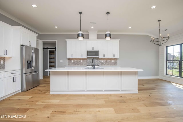 256 Watercrest Dr, Vonore, TN 37885 - kitchen with appliances with stainless steel finishes, ornamental molding, light countertops, tasteful backsplash, and a center island with sink