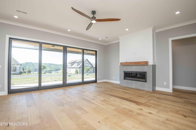 256 Watercrest Dr, Vonore, TN 37885 - unfurnished living room with a ceiling fan, light wood-style floors, crown molding, a tile fireplace, and recessed lighting