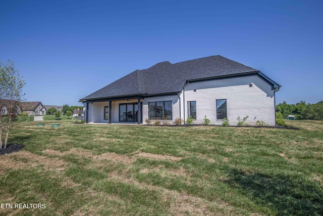256 Watercrest Dr, Vonore, TN 37885 - rear view of house featuring a yard, brick siding, and roof with shingles