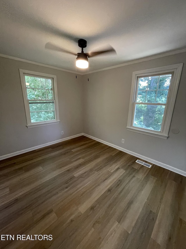 3431 Skyline Dr, Knoxville, TN 37914 - unfurnished room featuring ornamental molding, dark wood-style floors, healthy amount of natural light, and a ceiling fan