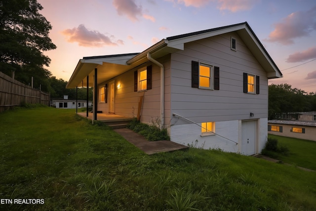 564 Dillwyn St, Kingsport, TN 37665 - back of house featuring an attached garage and a lawn