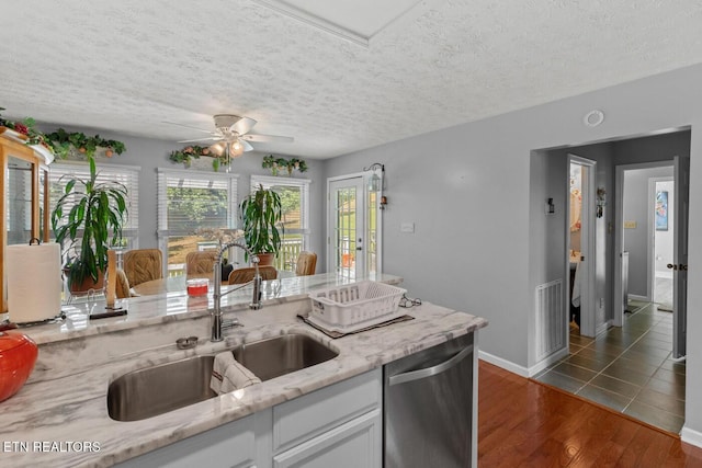 133 Rolling Hls, Rutledge, TN 37861 - kitchen with stainless steel dishwasher, ceiling fan, white cabinets, light stone countertops, and dark wood-style flooring