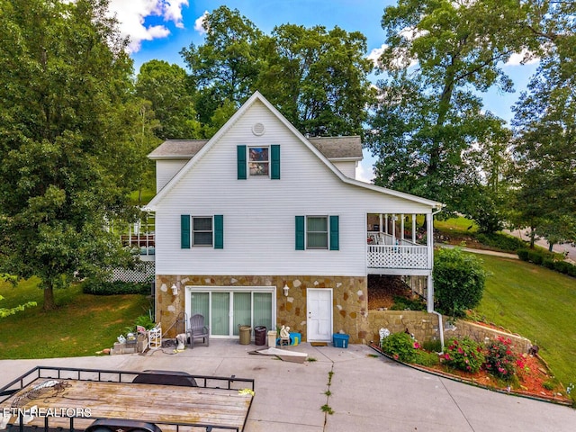 133 Rolling Hls, Rutledge, TN 37861 - back of house with stone siding, a patio area, and a lawn