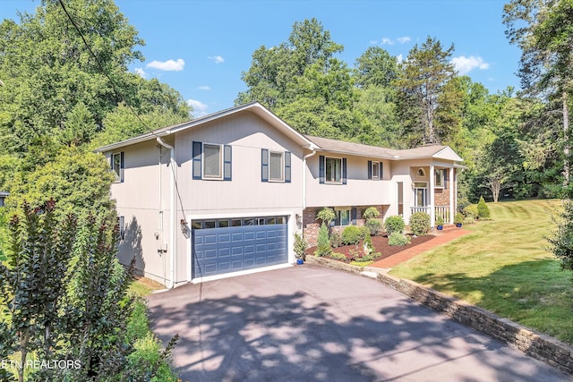 127 Newhaven Rd, Oak Ridge, TN 37830 - raised ranch with asphalt driveway, a garage, and a front lawn