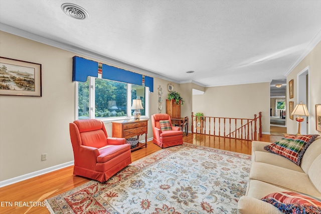 127 Newhaven Rd, Oak Ridge, TN 37830 - living room featuring ornamental molding, wood finished floors, plenty of natural light, and a textured ceiling